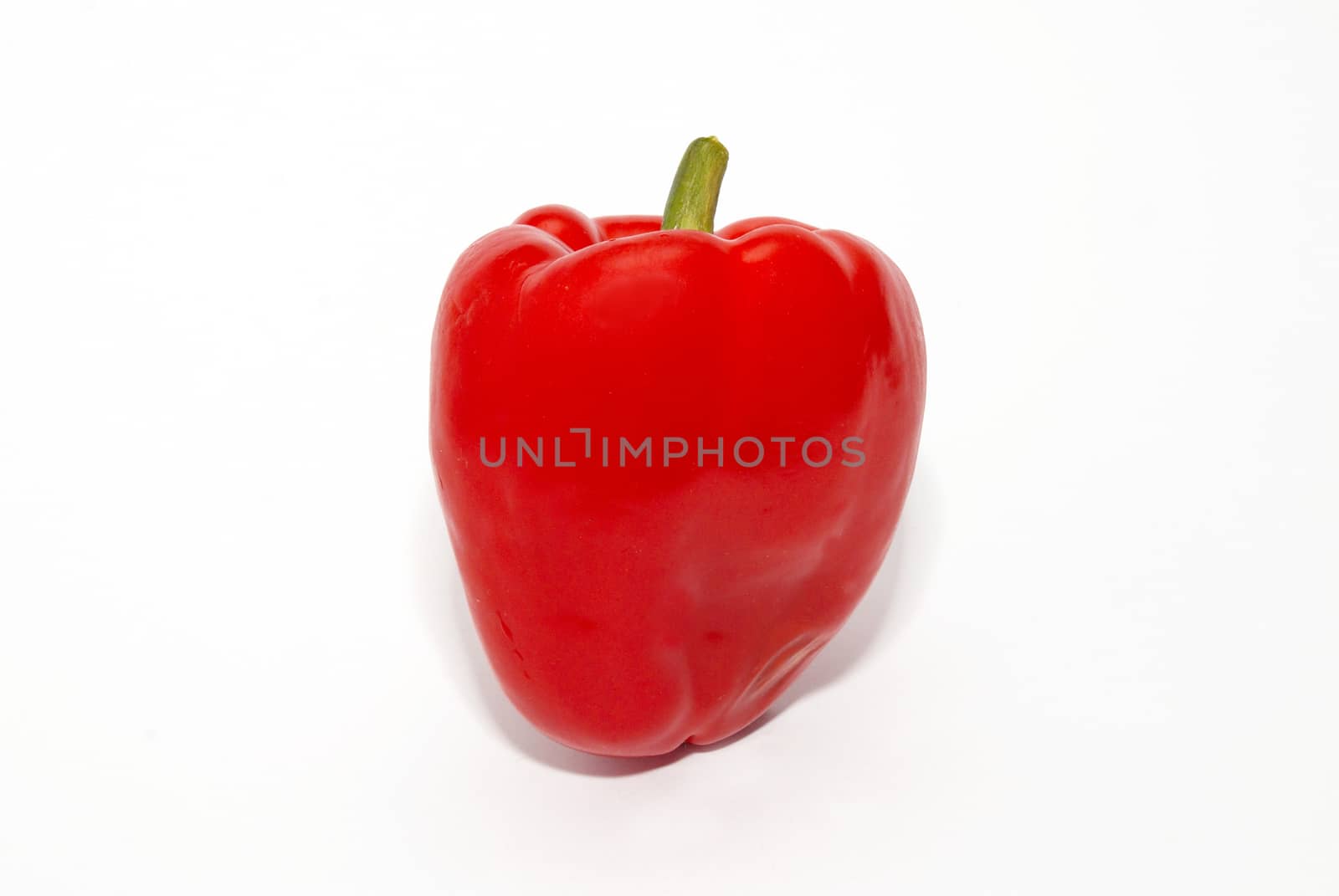 Red paprika isolated on white. by vapi