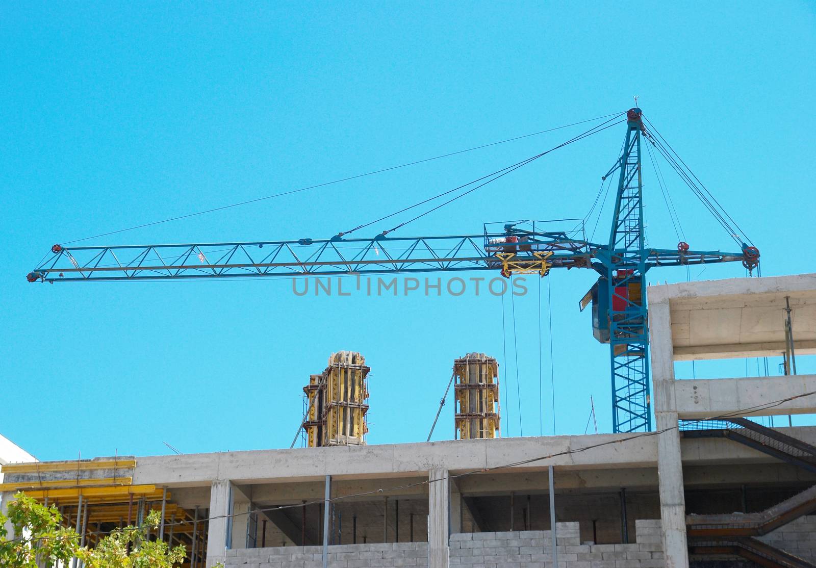 Building crane and the building under construction.