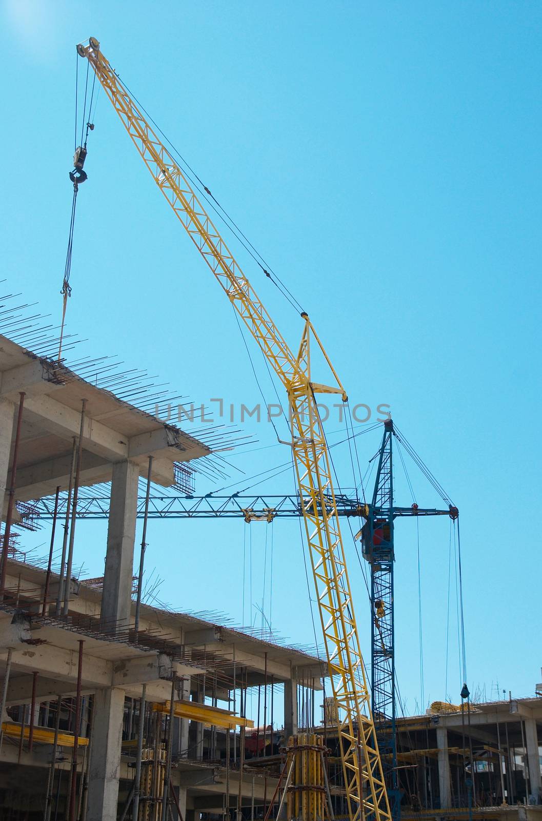 Building crane and the building under construction. by vapi