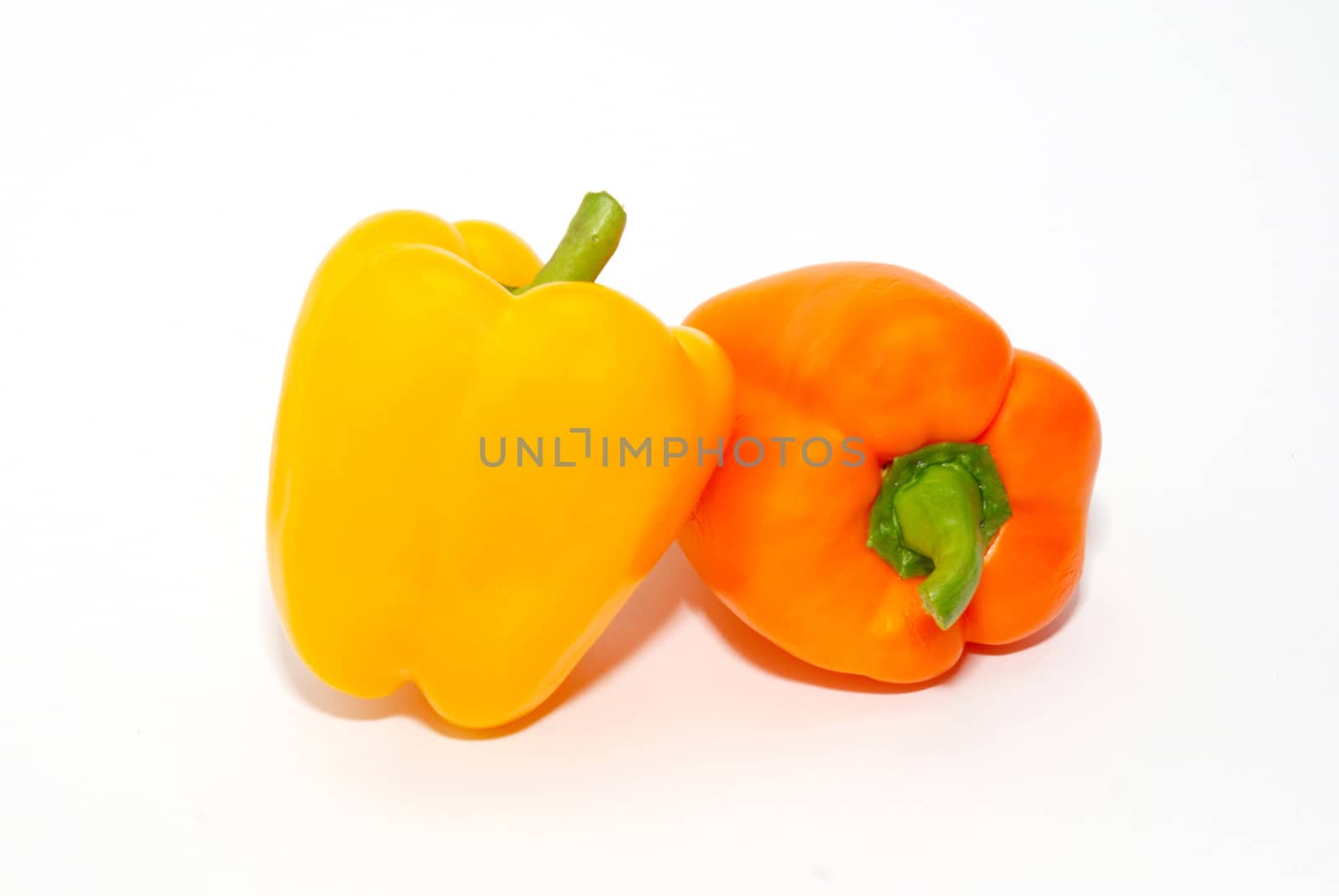 Orange and yellow paprika isolated on white. by vapi