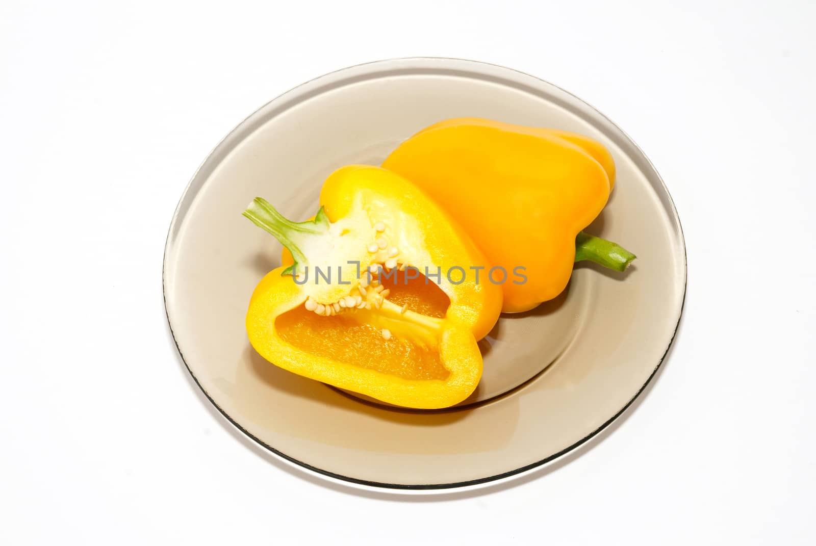 Yellow paprika on the plate on white background. by vapi