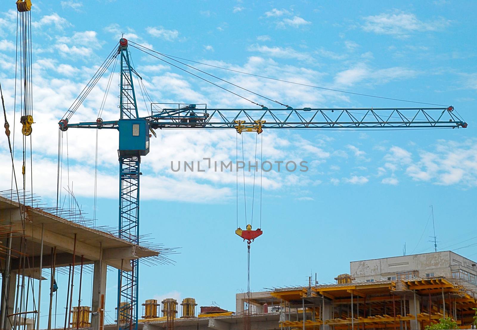 Building crane and the building under construction. by vapi