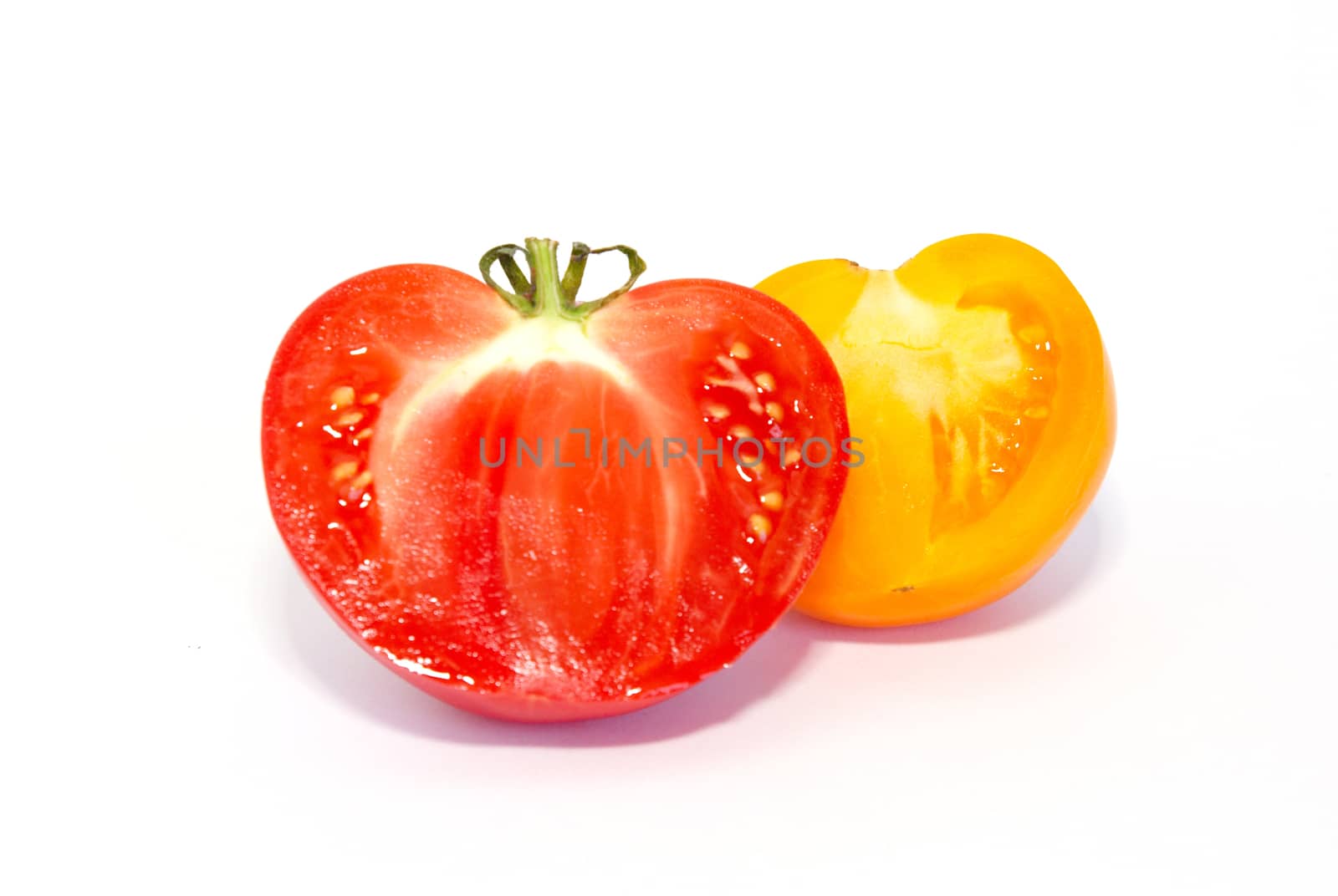 Two halves of fresh tomatoes isolated on white. by vapi