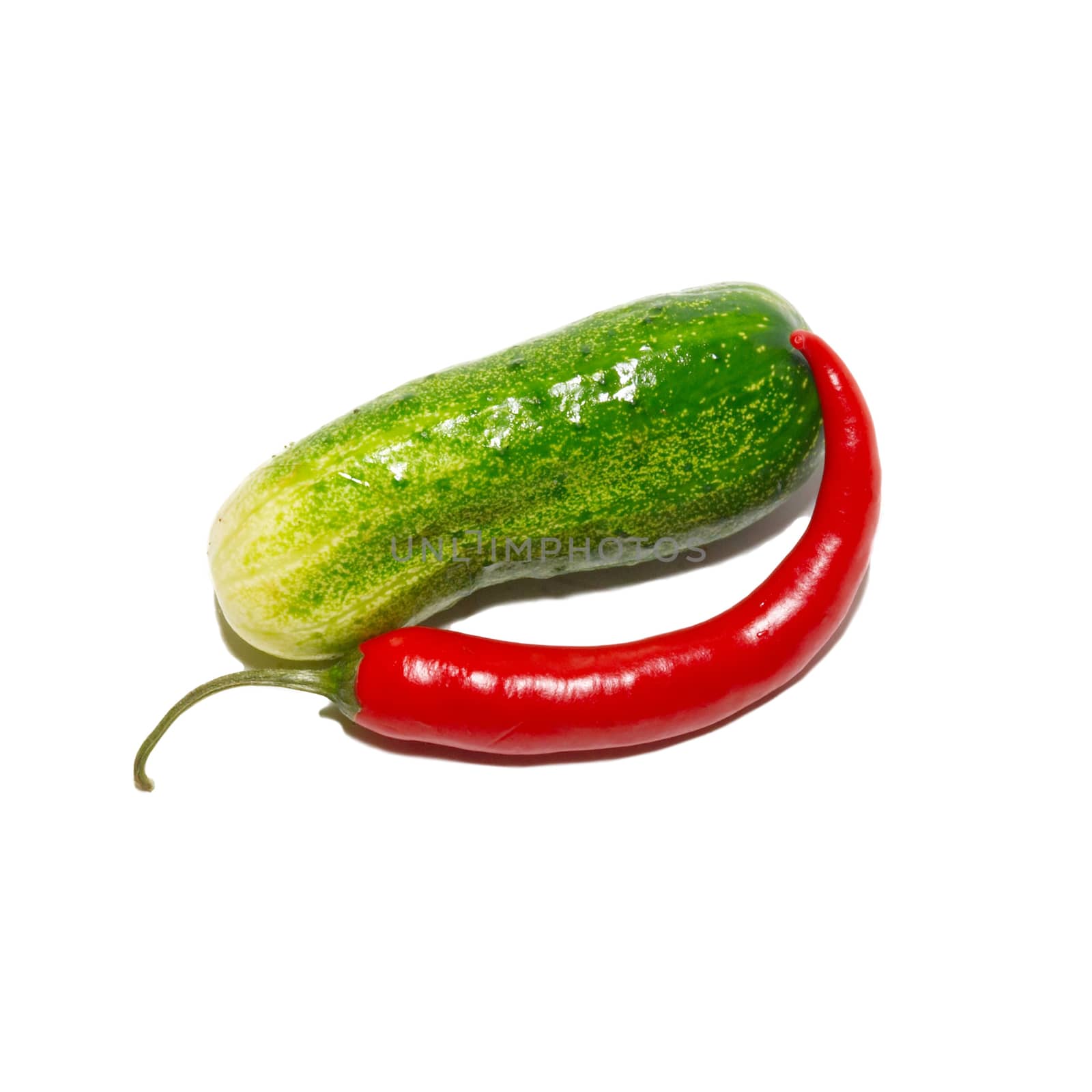 Cucumber and red pepper isolated on white.