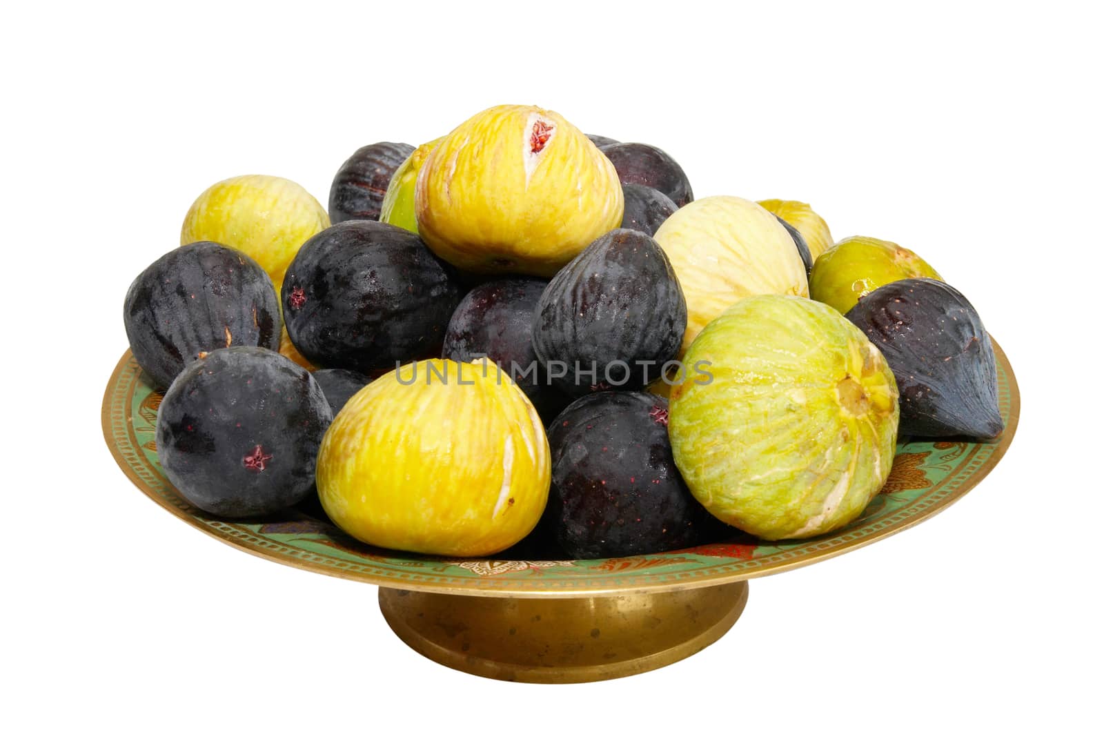 Stack of black and yellow figs on the plate isolated on white.