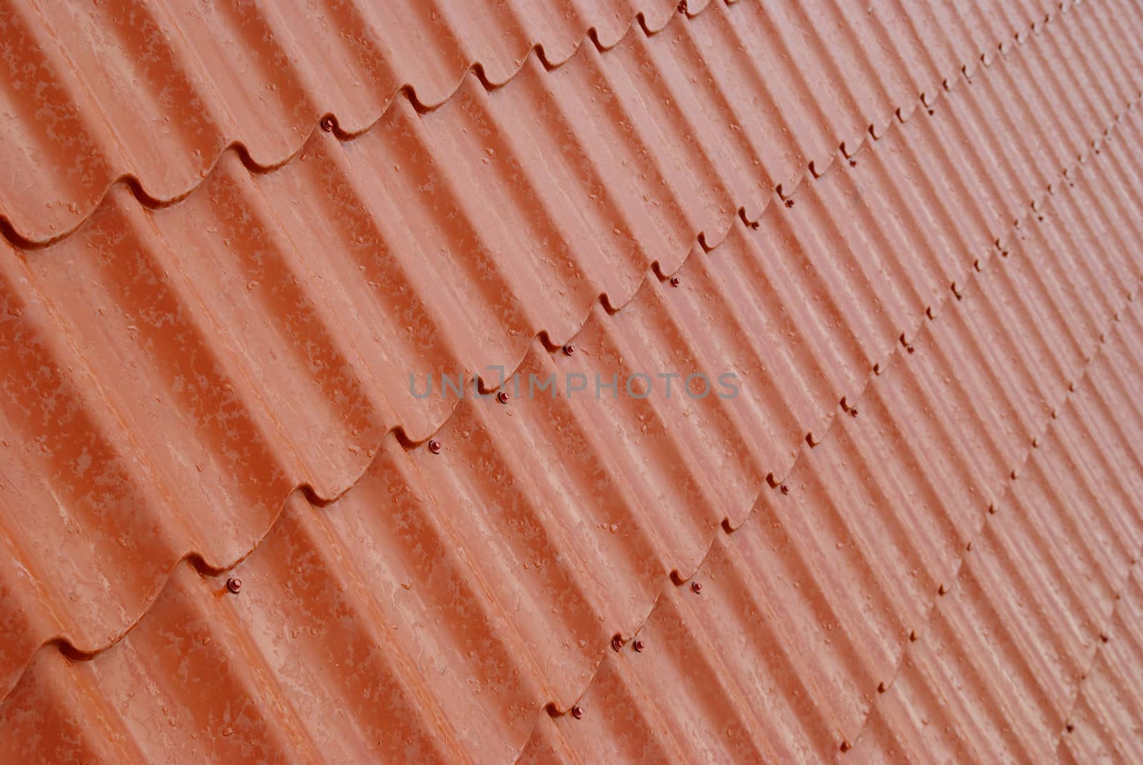 Wall of textured red tile.