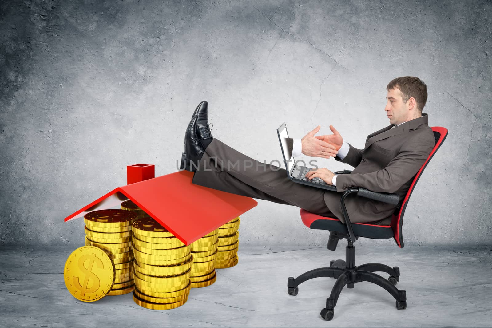 Businessman giving hand to laptop with pile of coins on grey wall background