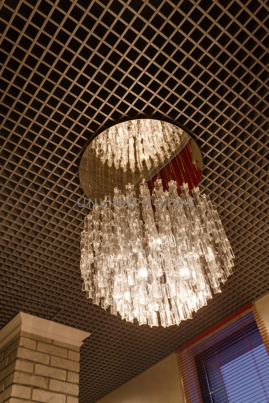 the magnificent crystal chandelier hanging on a ceiling