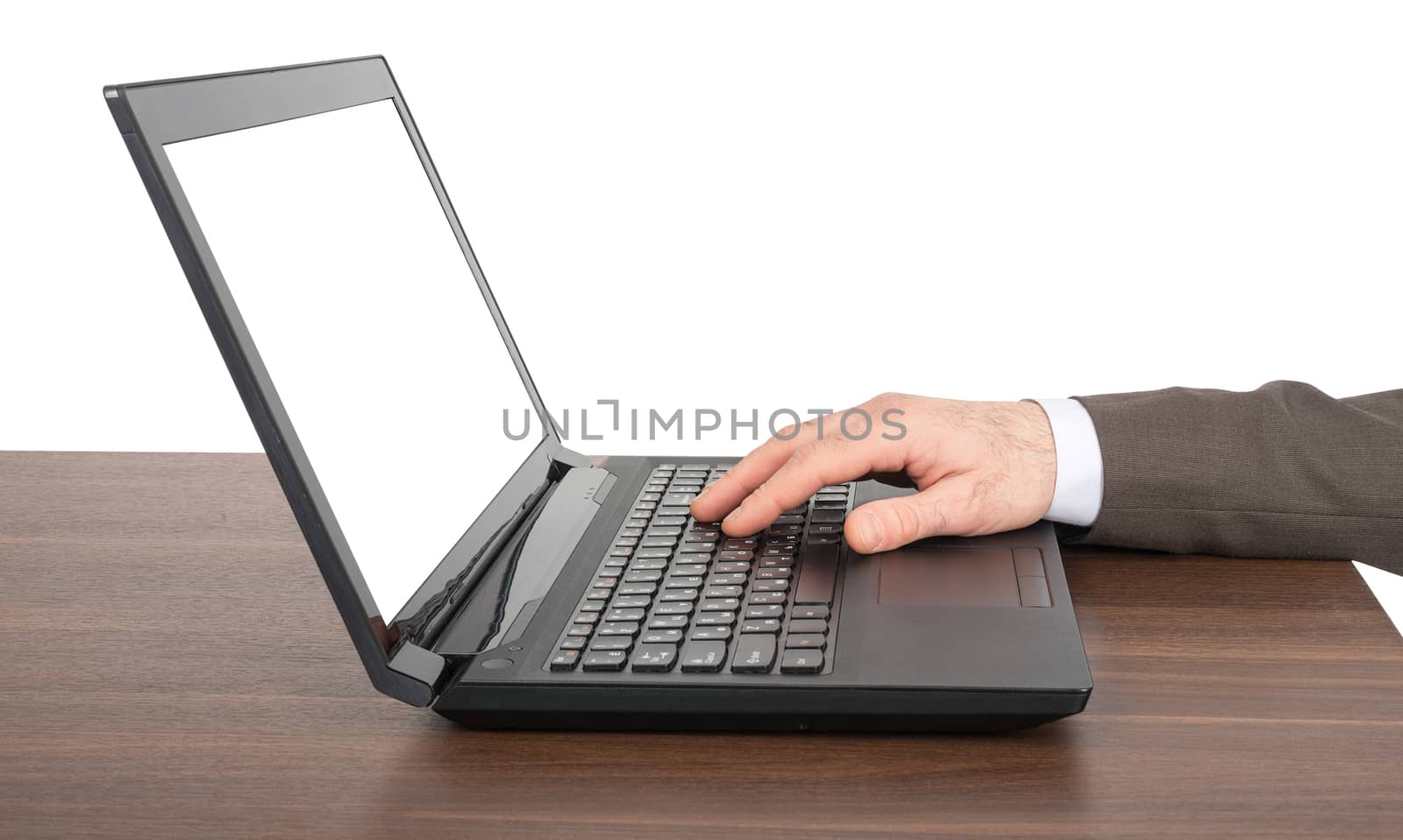 Businessmans hand working on laptop at table isolated on white background