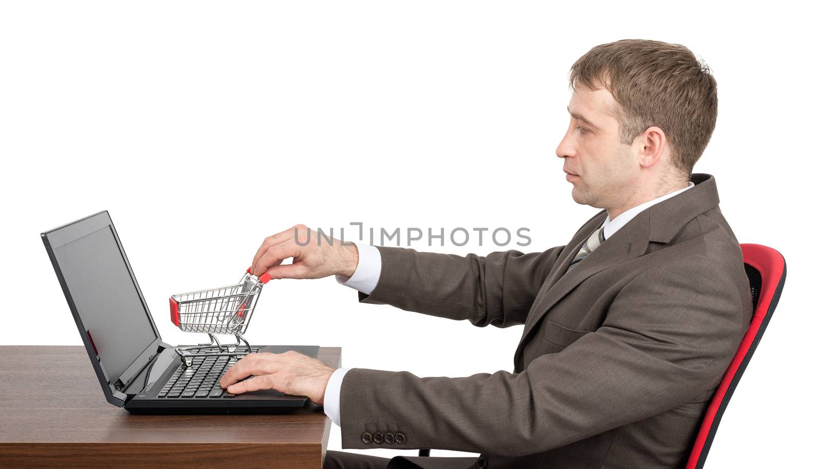 Businessman giving shopping cart to laptop isolated on white background