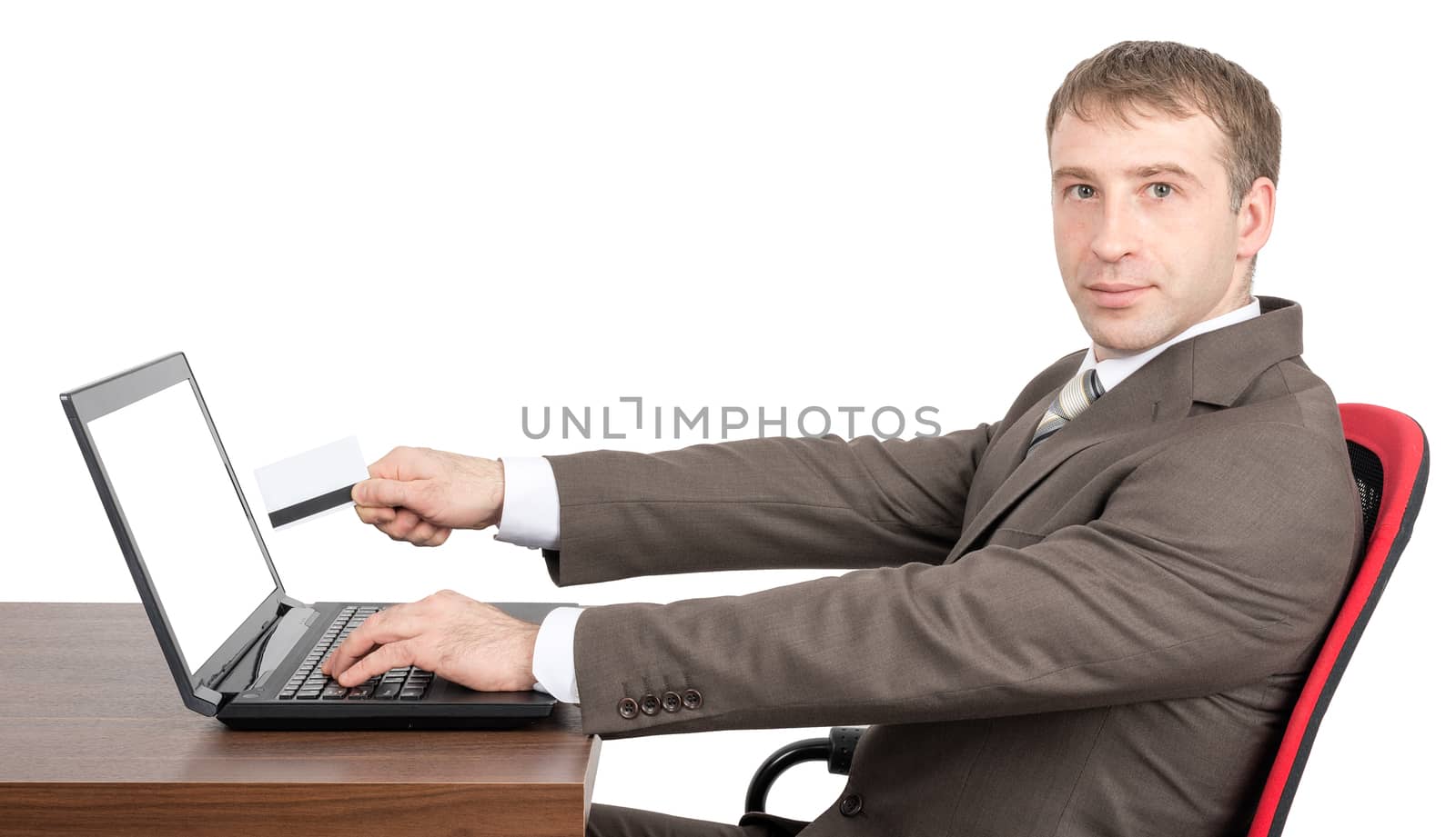 Businessman giving to laptop credit card by cherezoff