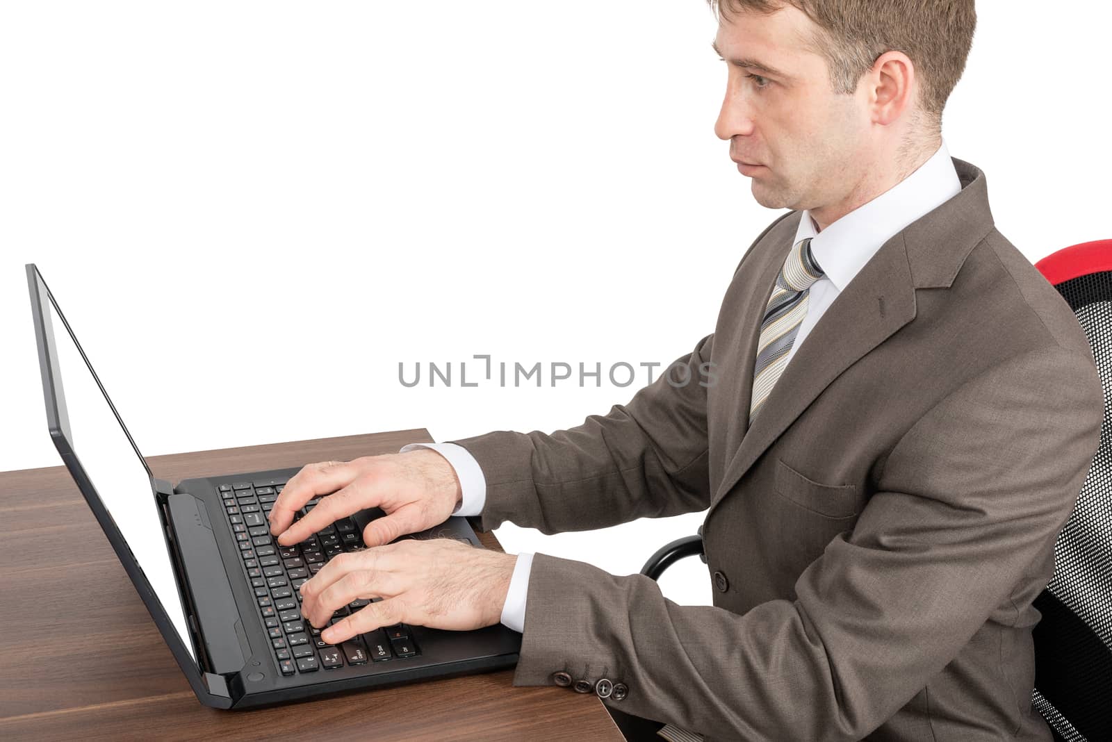 Businessman working on laptop at table isolated on white background