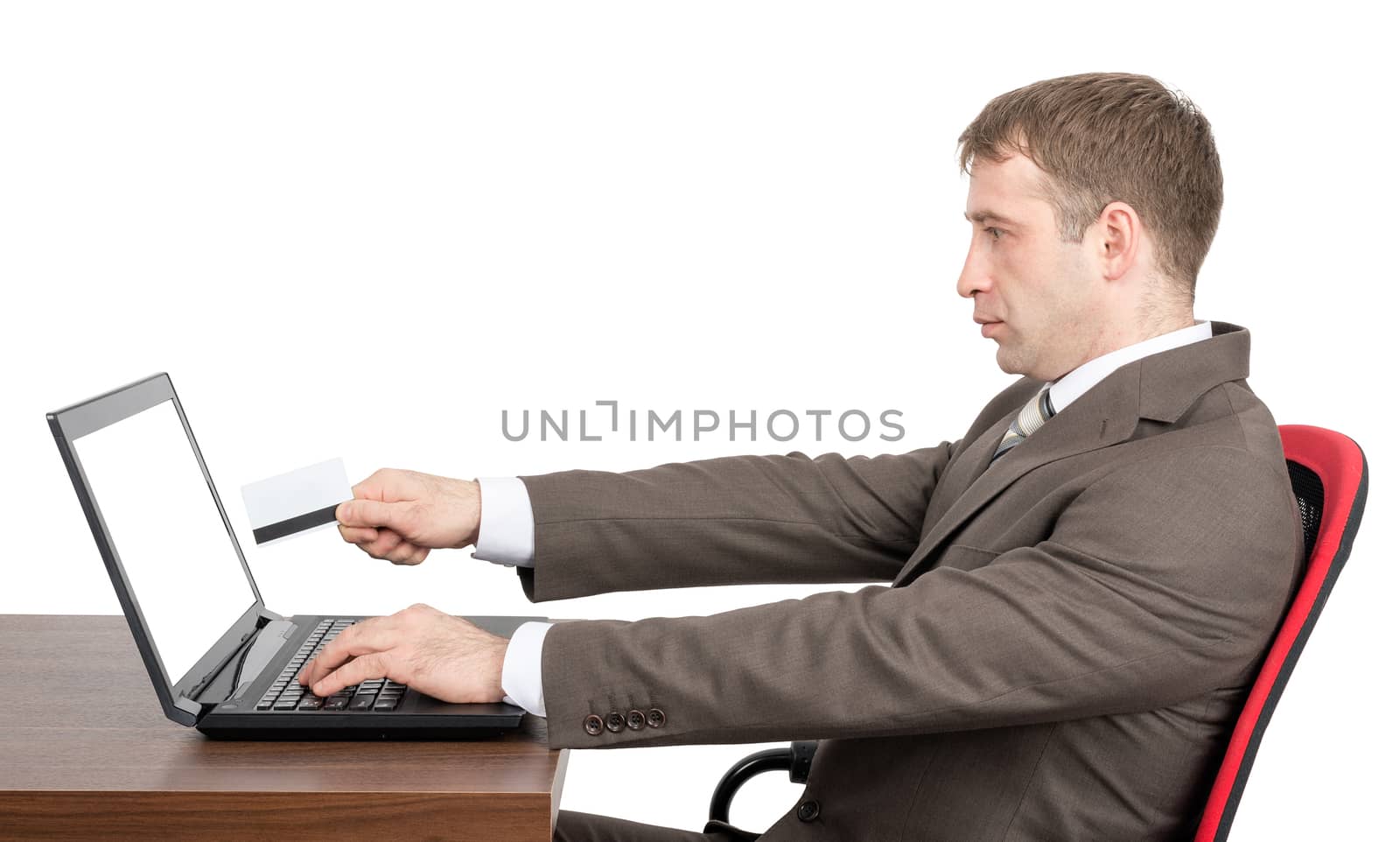 Businessman giving to laptop credit card by cherezoff