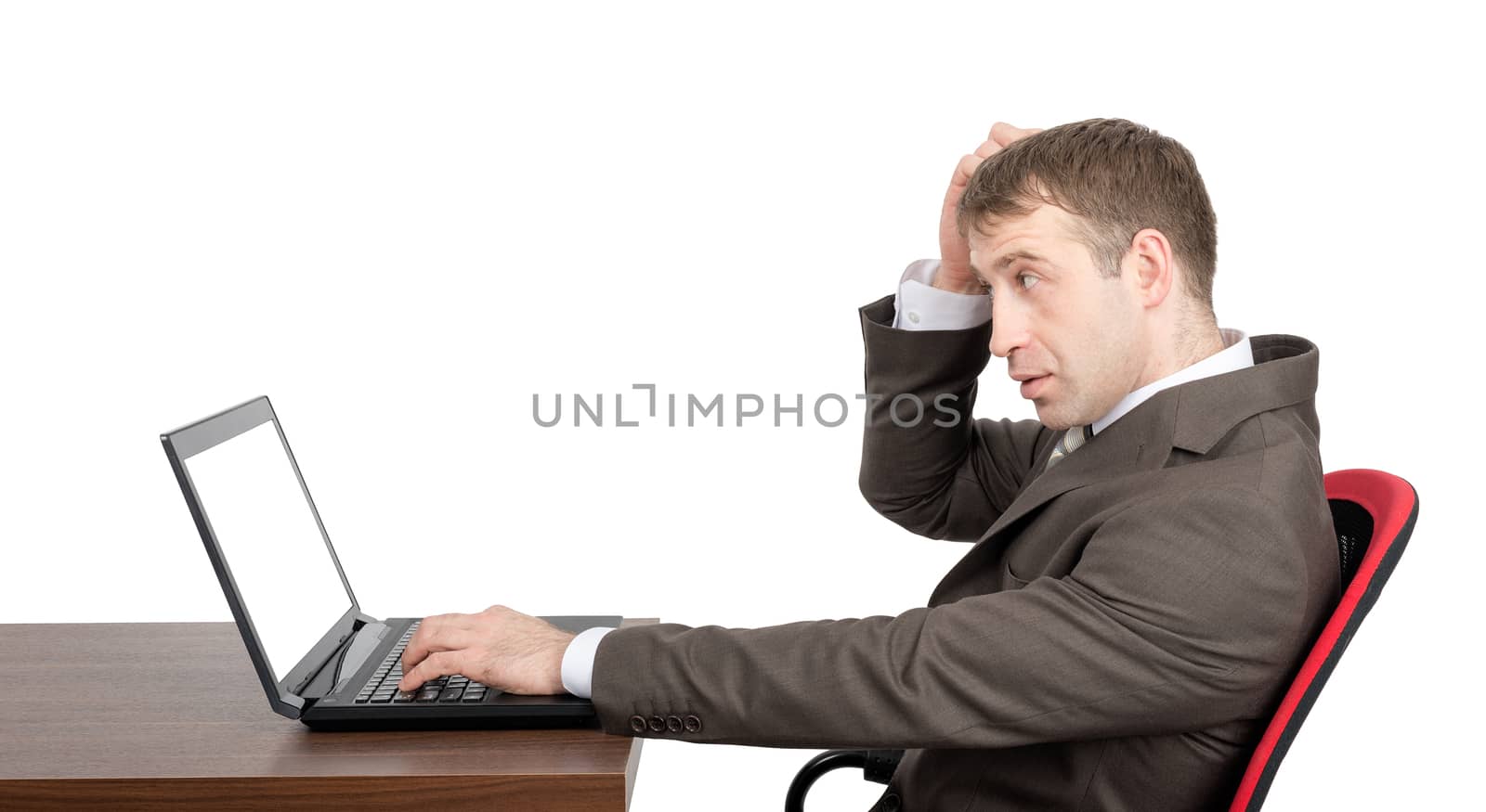 Thinking businessman working on laptop with blank screen isolated on white background