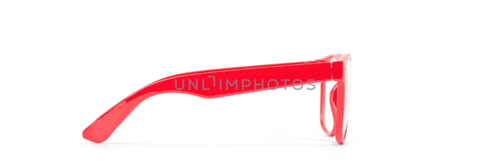 Pair of red eyeglasses isolated on white background, side vie