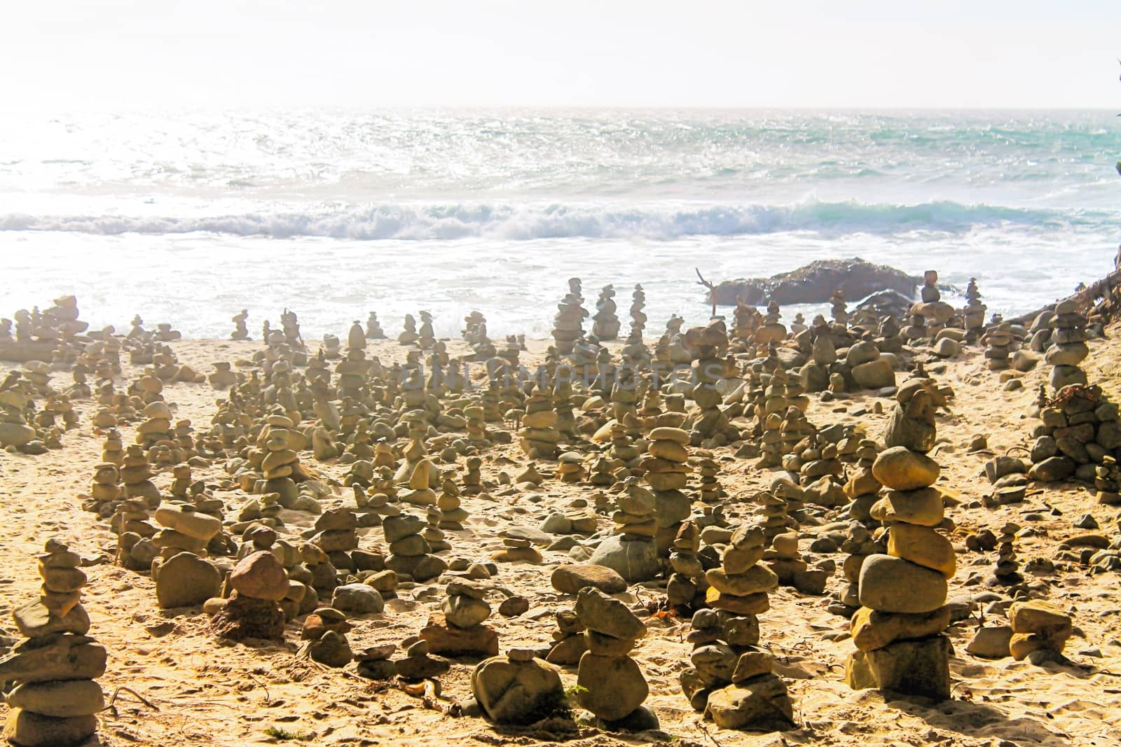 rock balancing at the beach with summer sunlight by Timmi