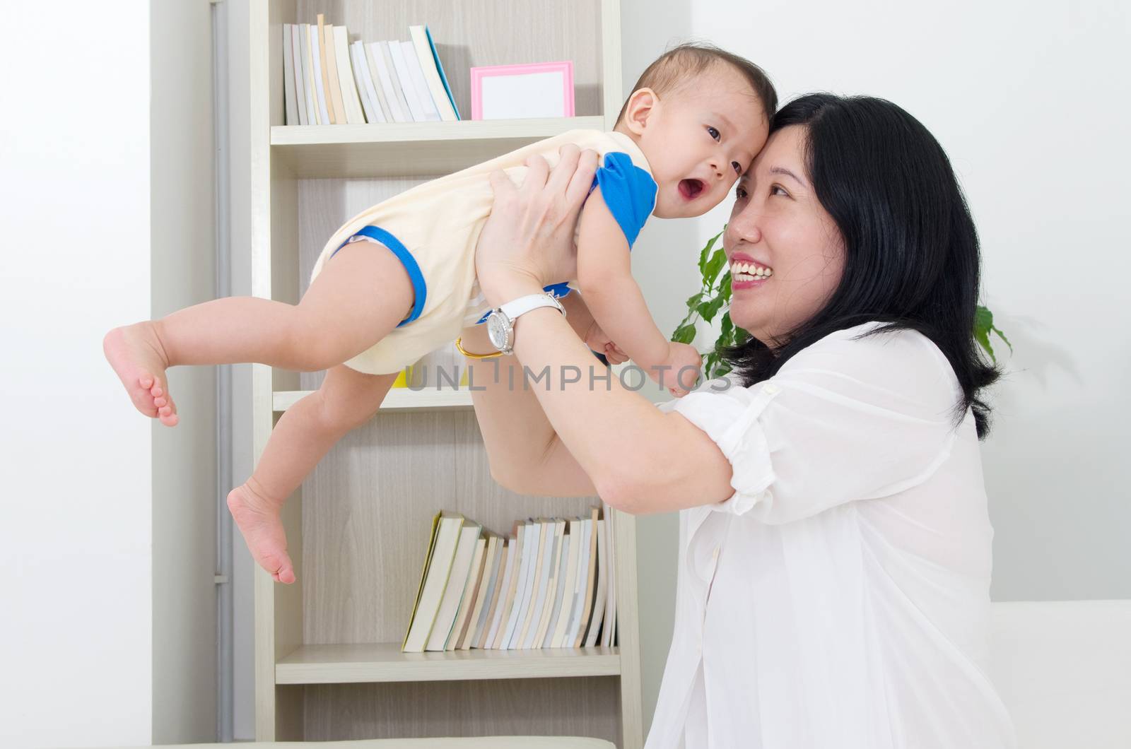 Asian mother playing with her baby