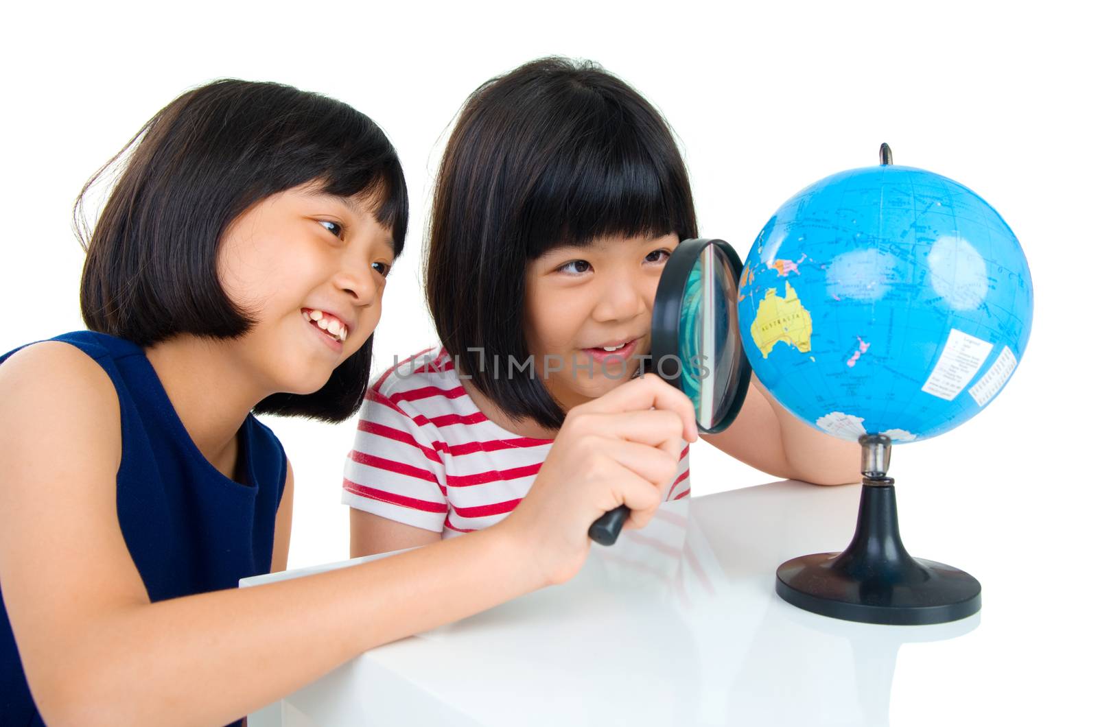 Asian kids looking at the globe