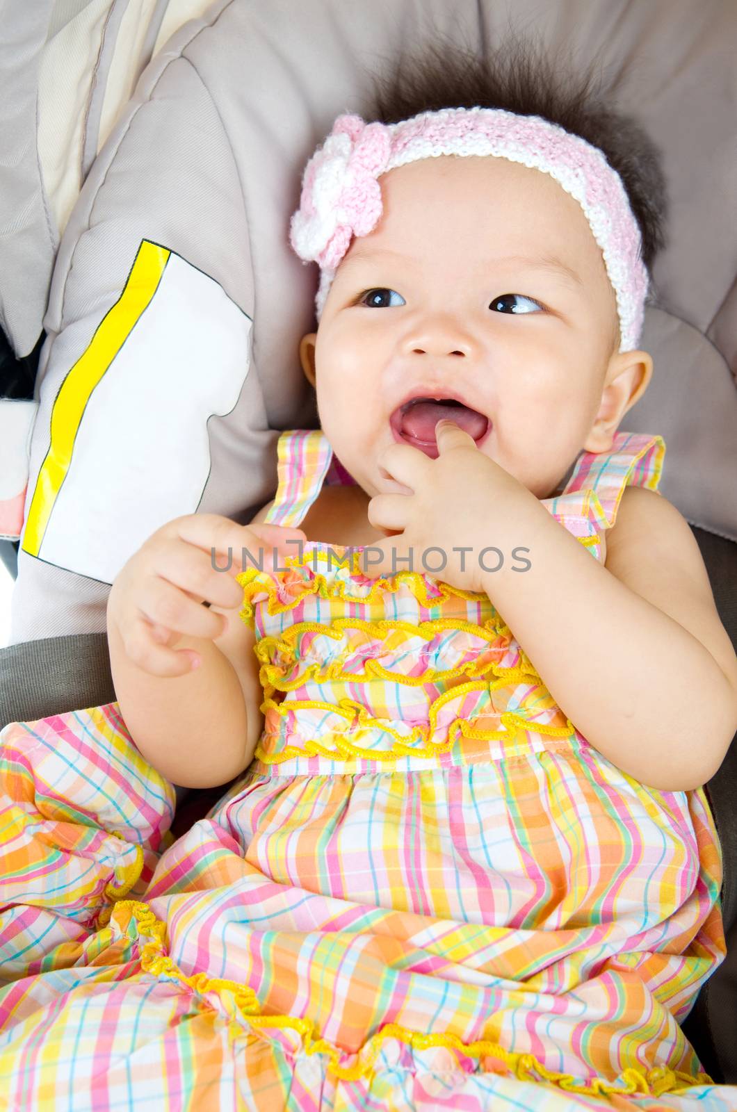 Portrait of sweet baby girl in baby seat