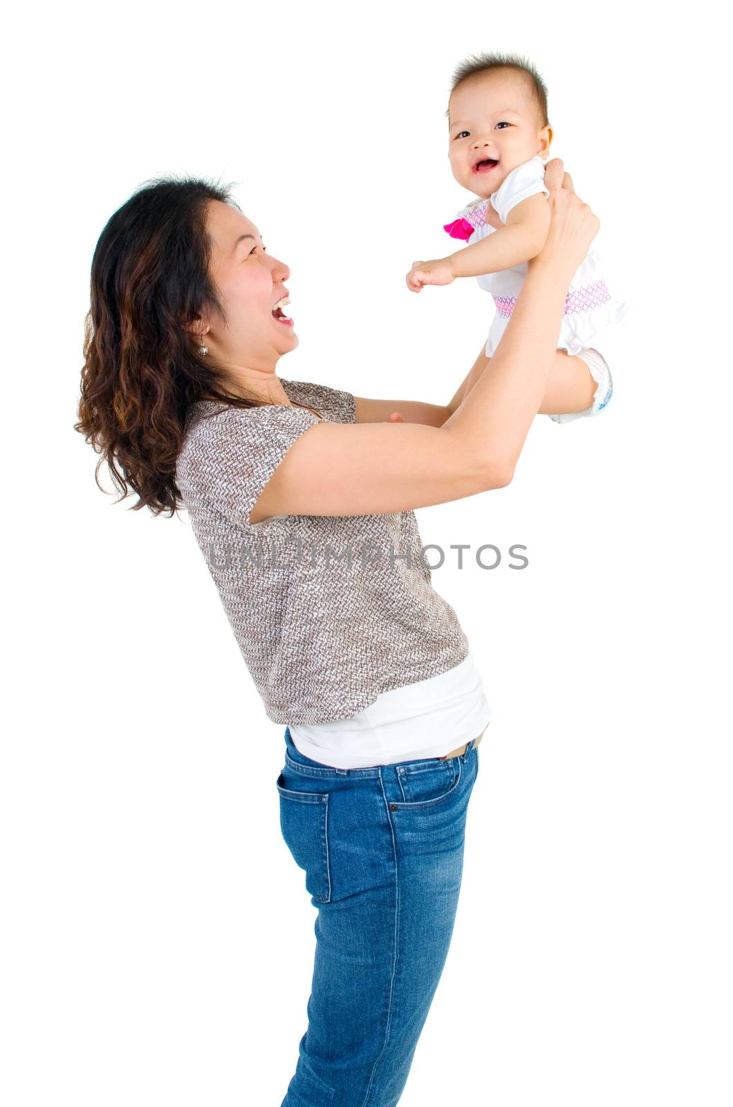 Asian mother lifting up her baby