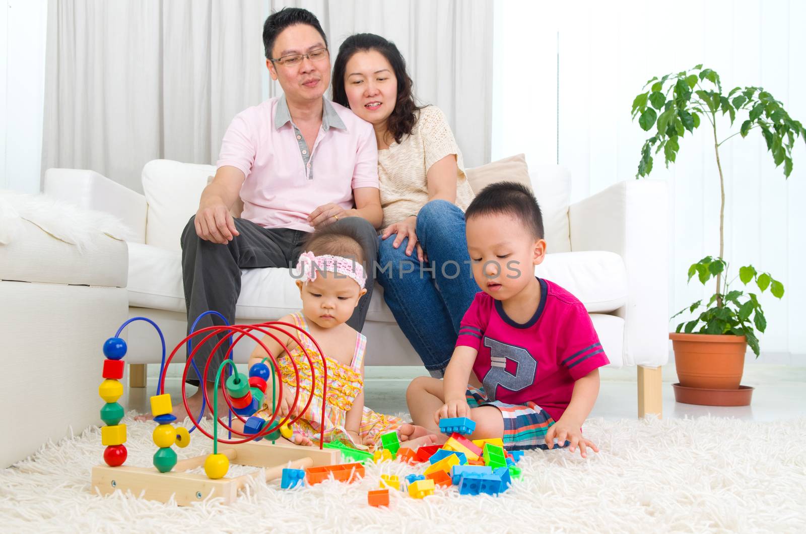 Asian family playing toys