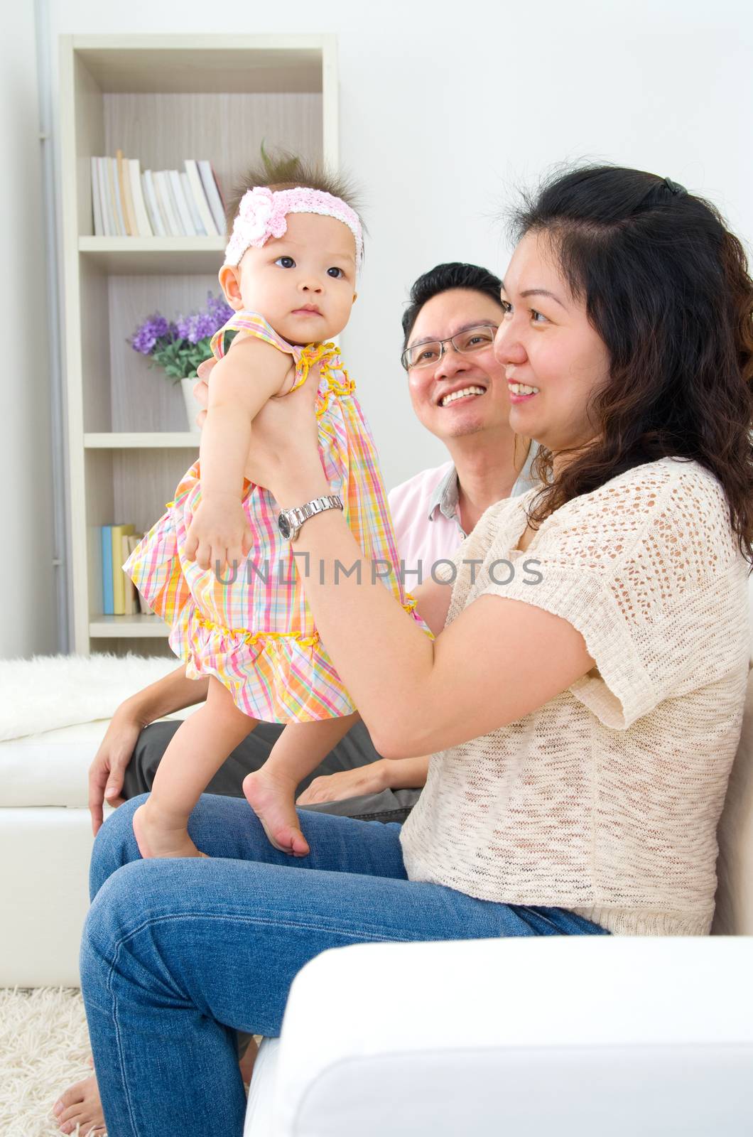 Asian parent playing with their daughter 