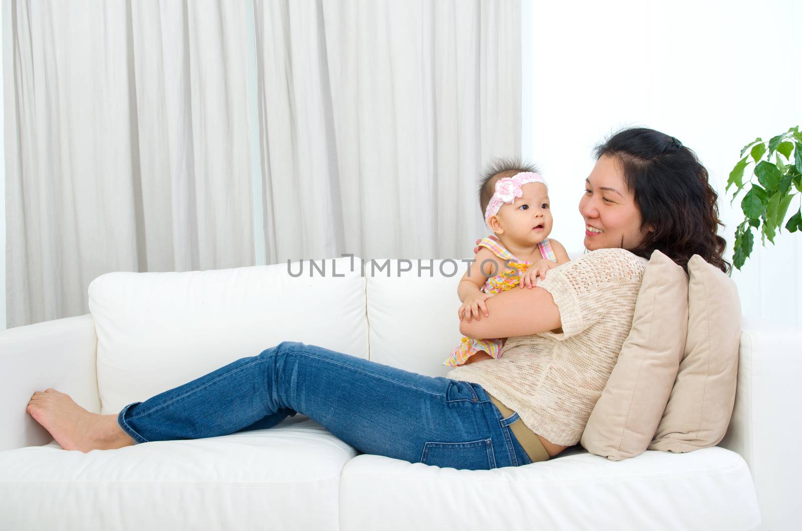 Asian mother playing with her baby