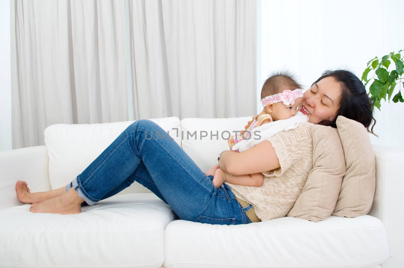 Asian mother playing with her baby