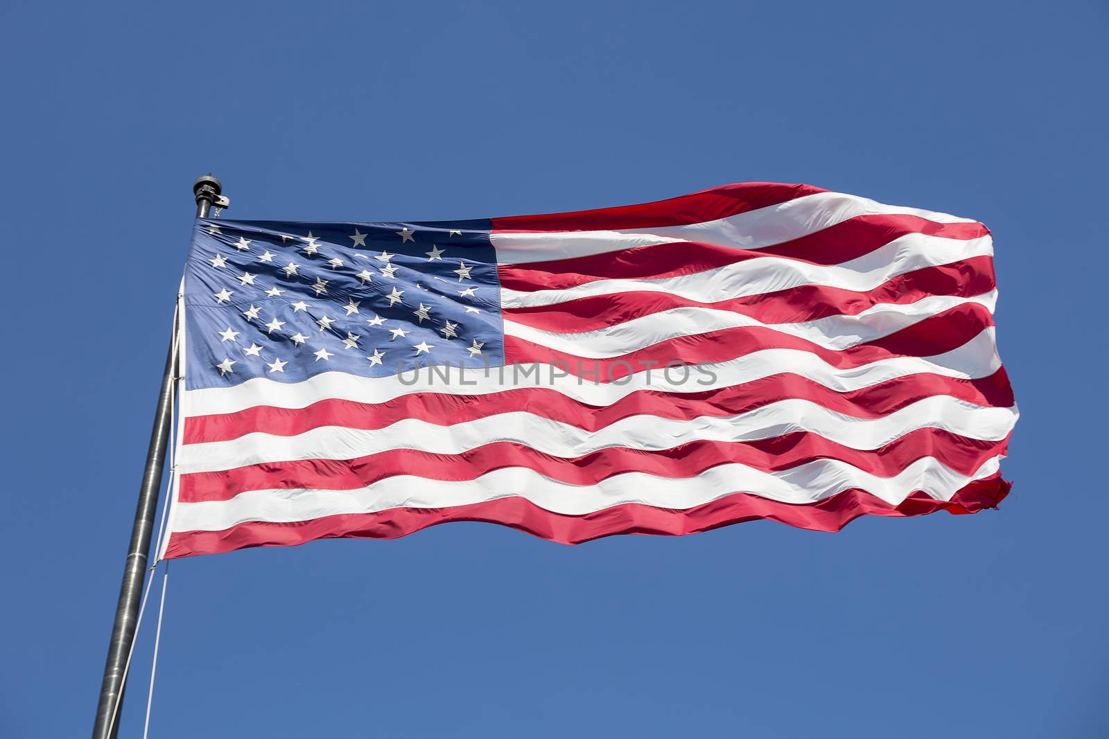 American flag on the blue sky, USA.