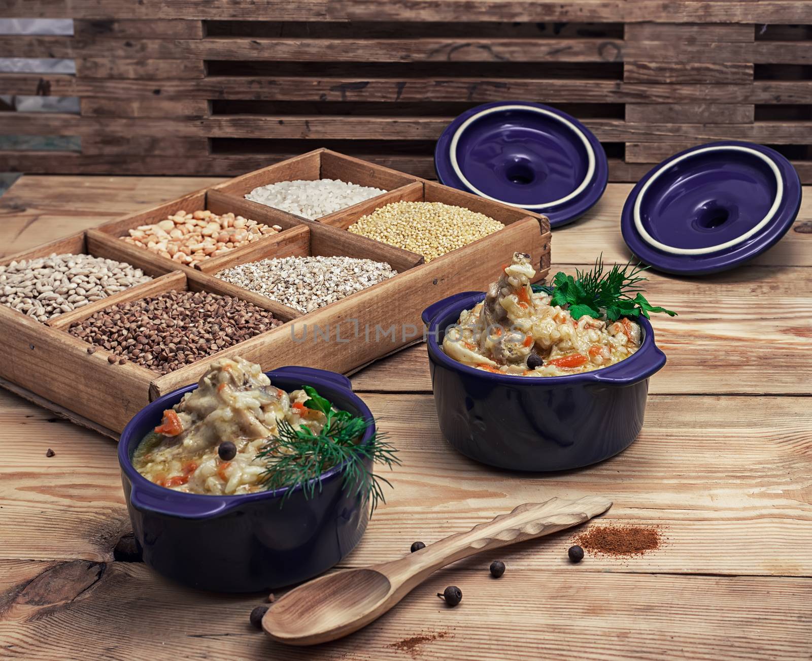rice pilaf on the background wooden boxes with raw cereals in rustic style