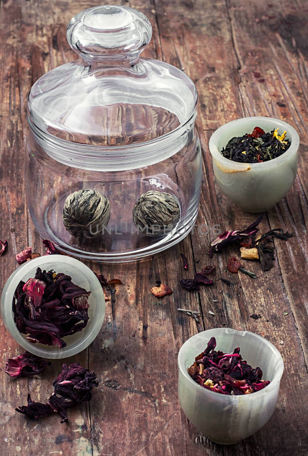 different varieties of brewed leaf tea in glass jar. The image is tinted in vintage style