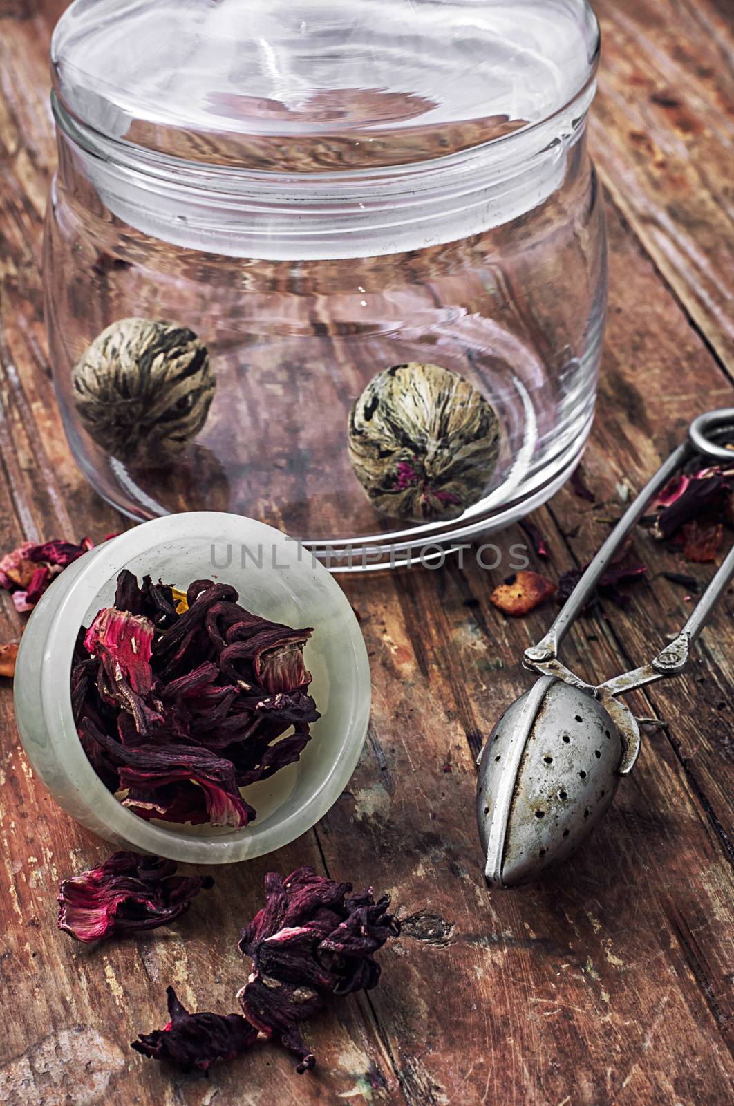 different varieties of brewed leaf tea in glass jar. The image is tinted in vintage style