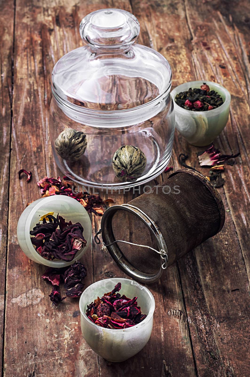 different varieties of brewed leaf tea in glass jar. The image is tinted in vintage style