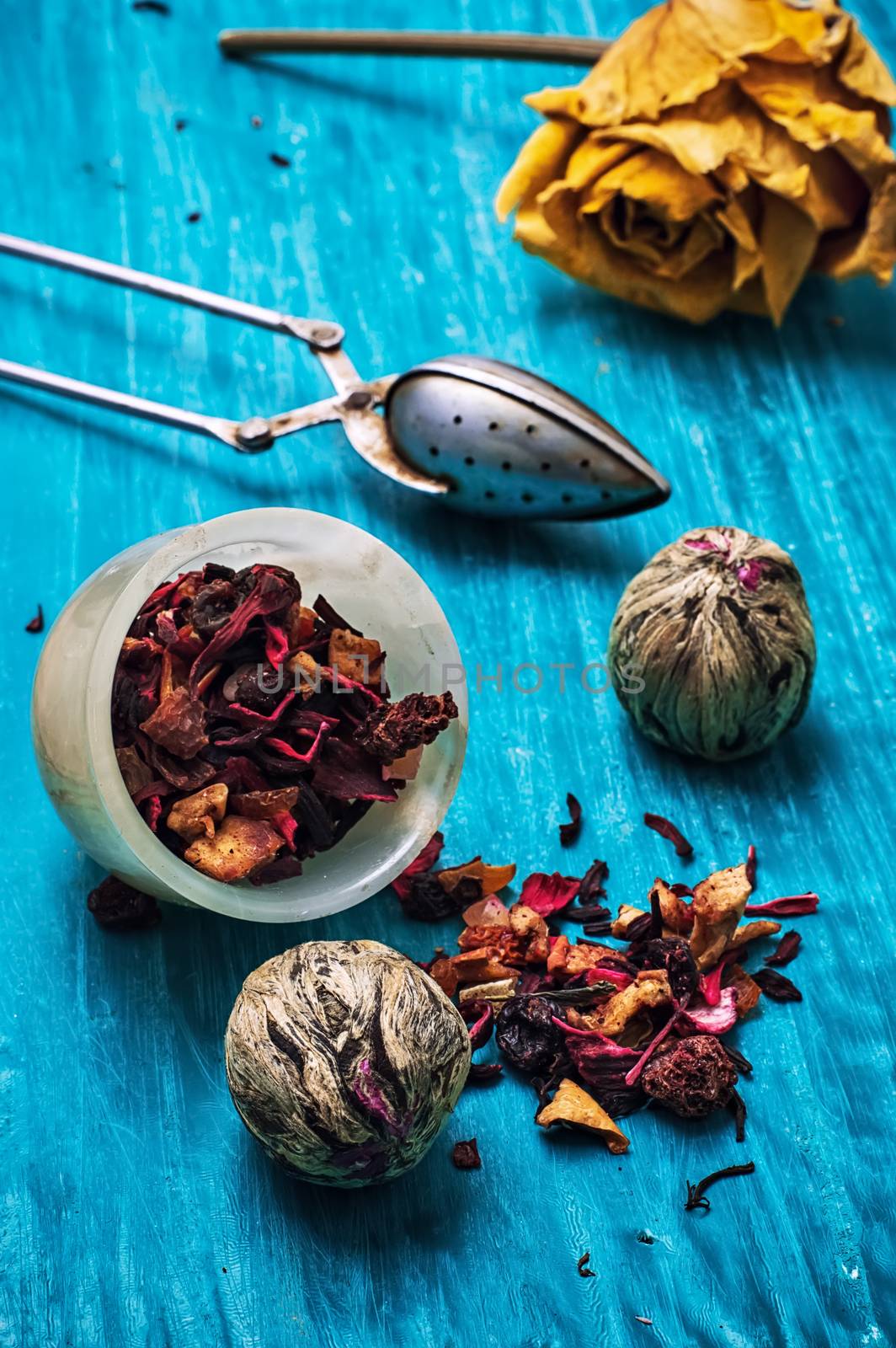 dried fragrant tea leaves on wooden turquoise background.Shallow DOF