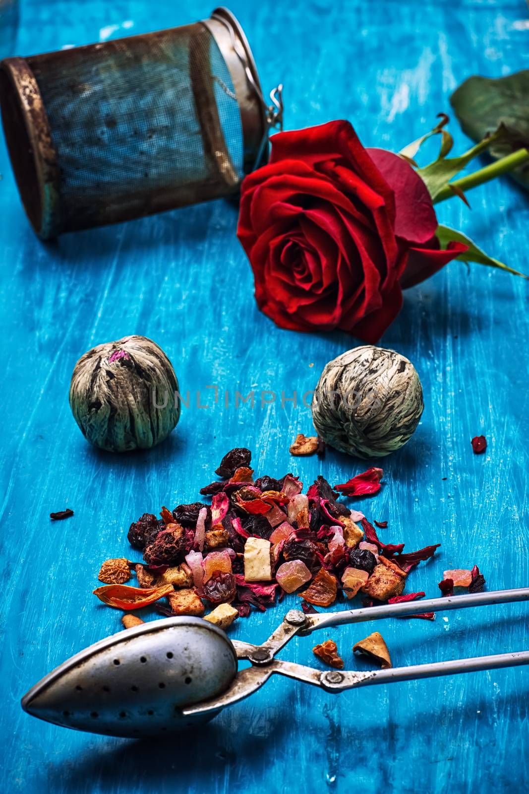 dried fragrant tea leaves on wooden turquoise background.Shallow DOF