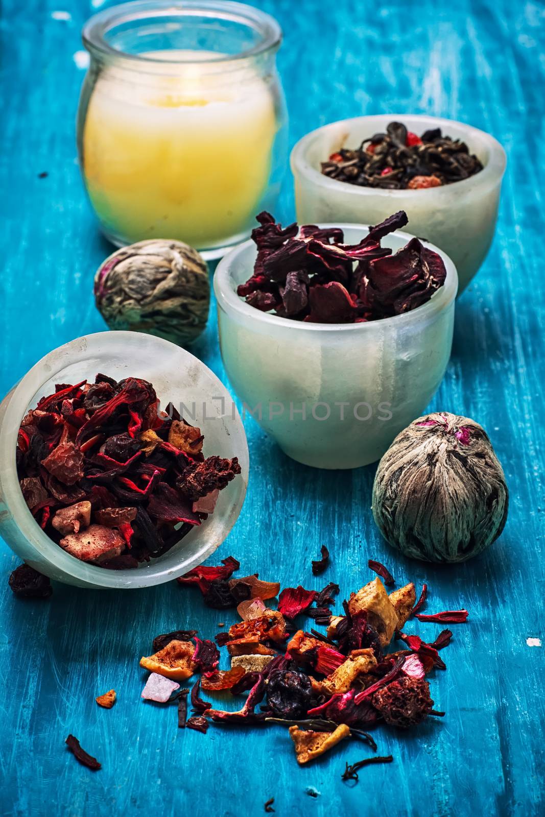 dried fragrant tea leaves on wooden turquoise background.Shallow DOF