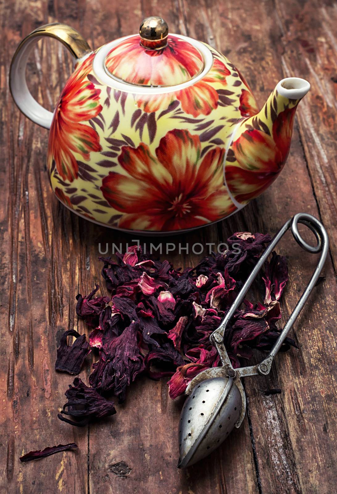 the teapot in the background of elite sorts of tea.the image is tinted in vintage style