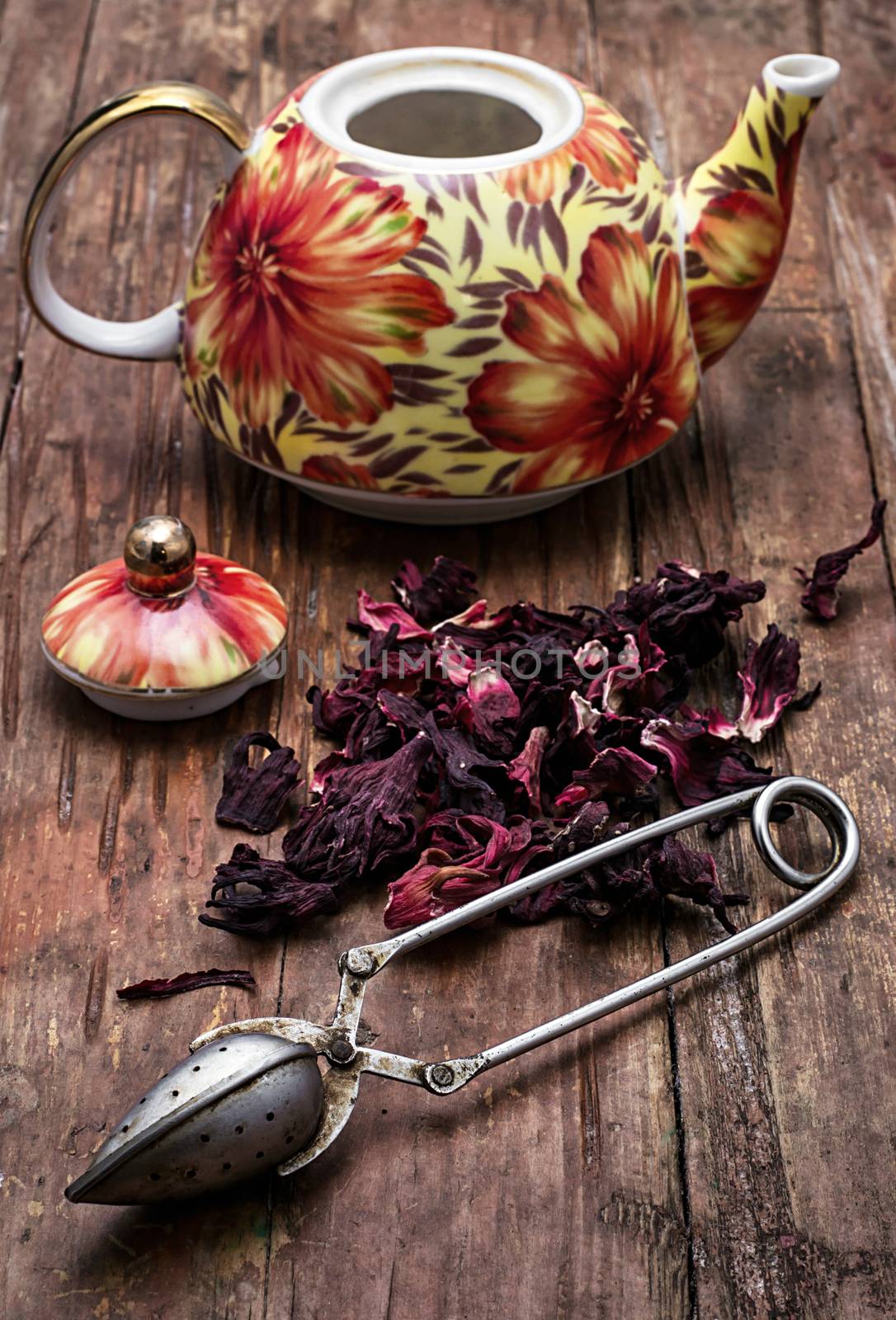 the teapot in the background of elite sorts of tea.the image is tinted in vintage style
