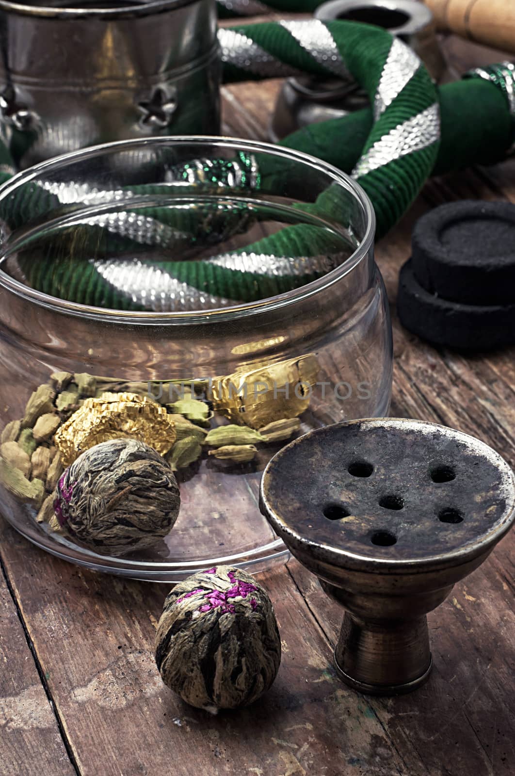 details hookah and dry elite tea leaves on wooden background.The toned image