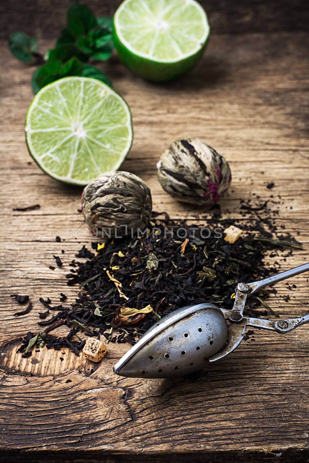 tea brew with lime and mint on wooden background  by LMykola