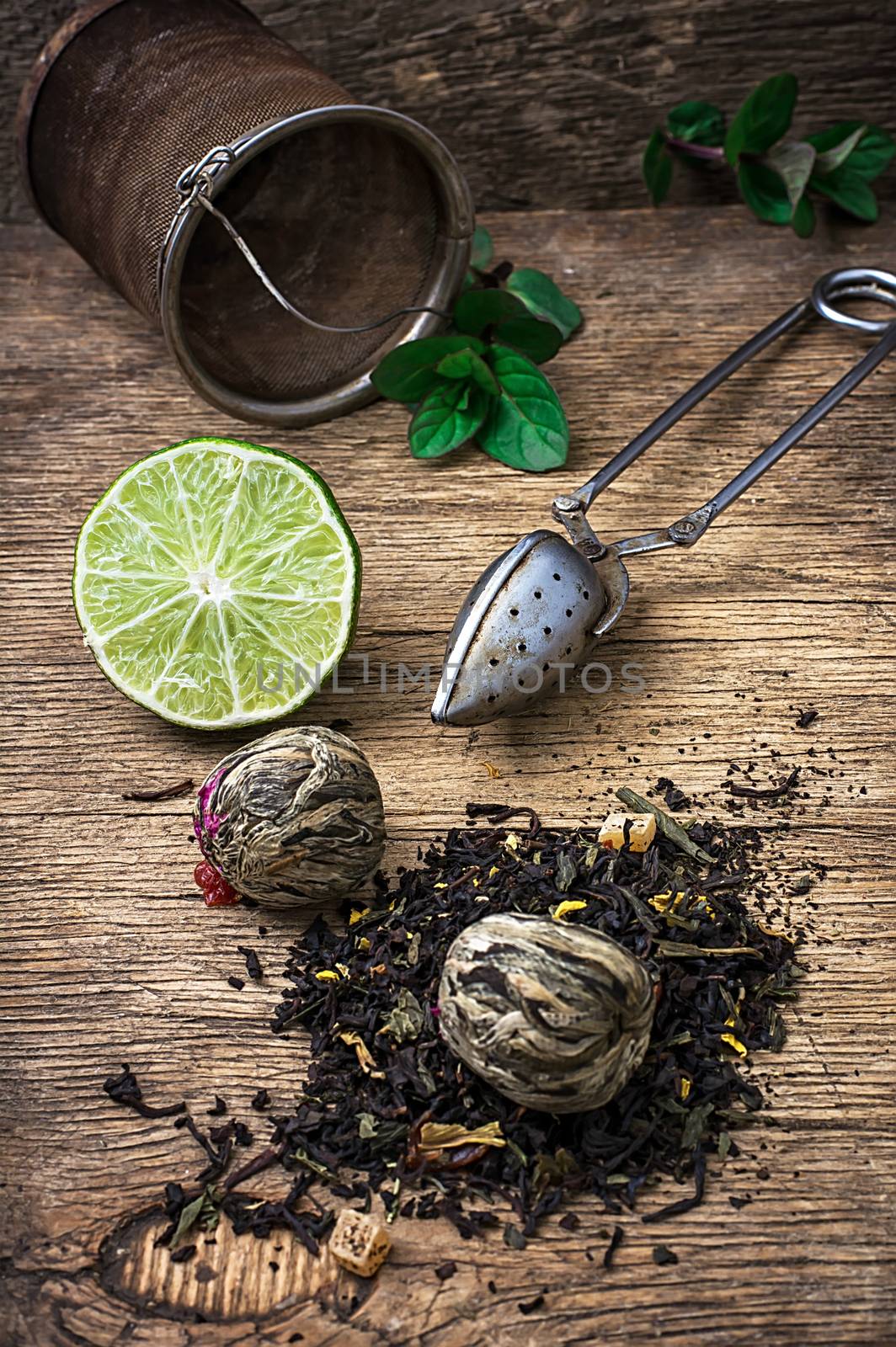 tea brew with lime and mint on wooden background  by LMykola