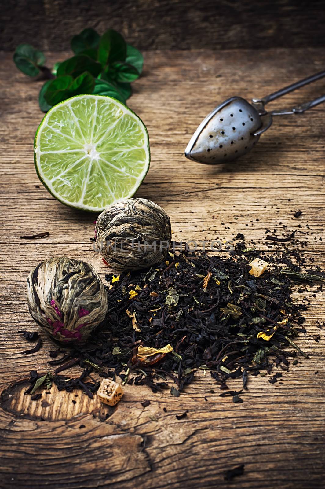 tea brew with lime and mint on wooden background  by LMykola