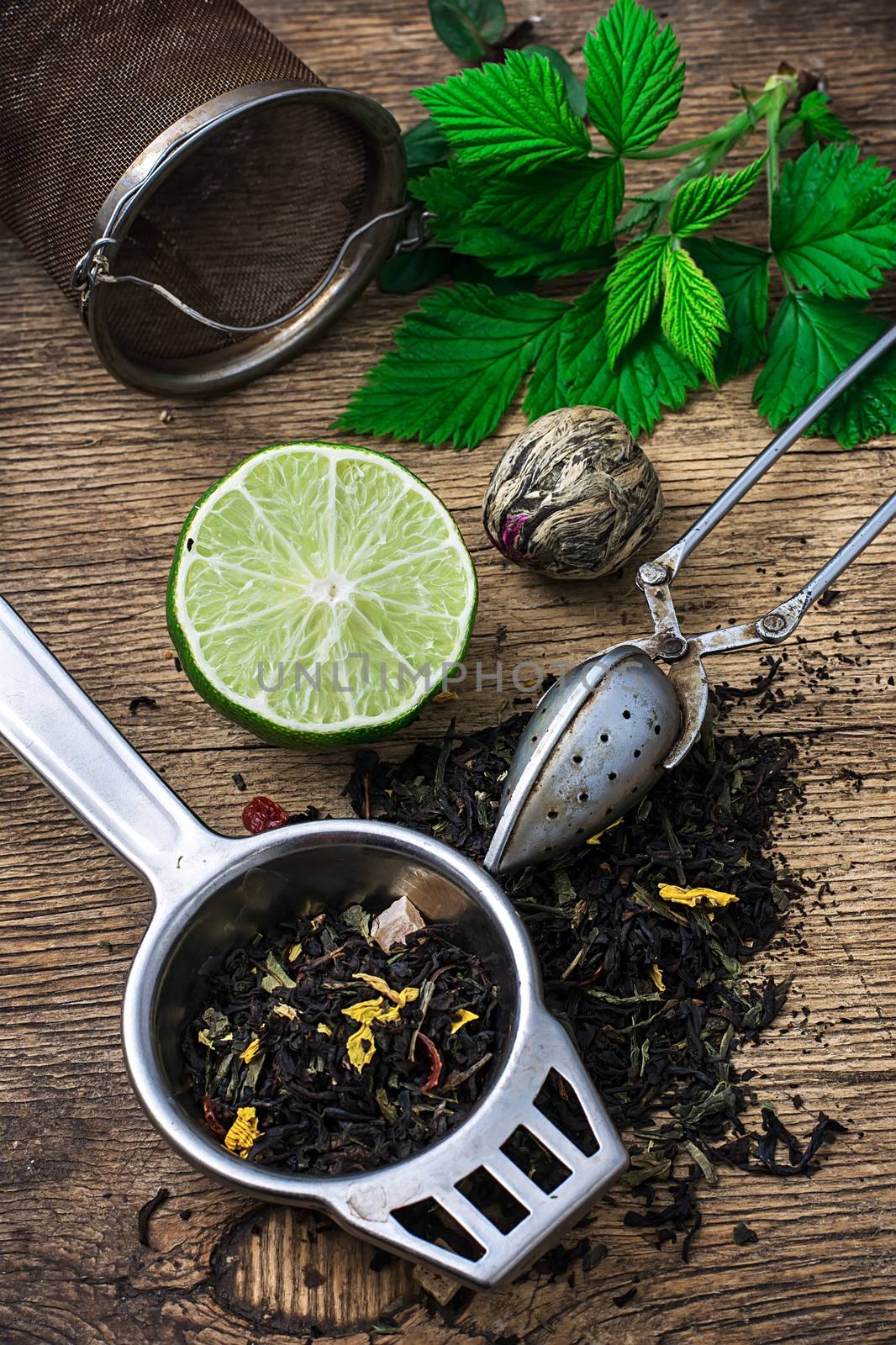 tea brew with lime and mint on wooden background  by LMykola