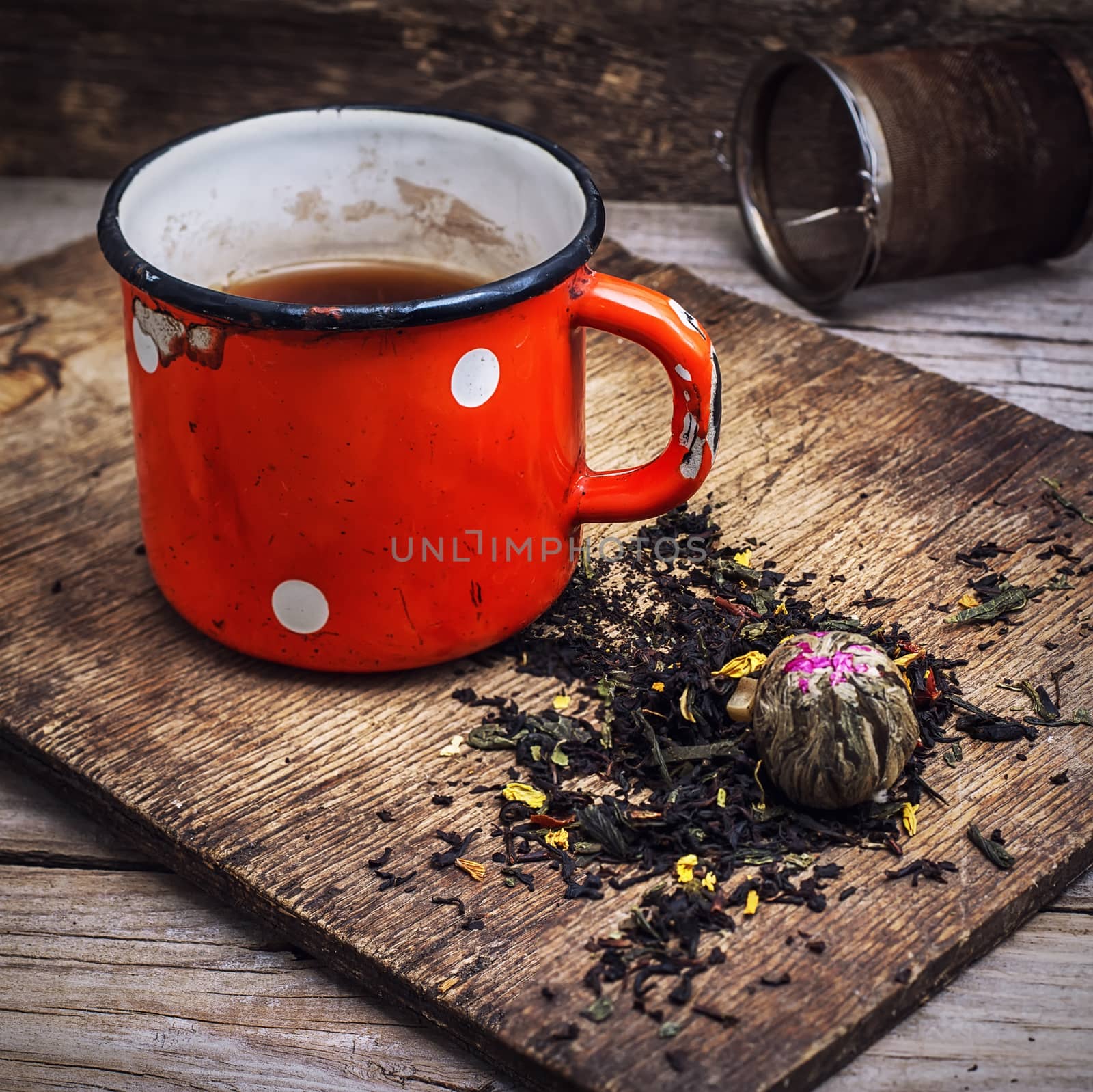 old iron cup of tea amid the scattered village on the welding table