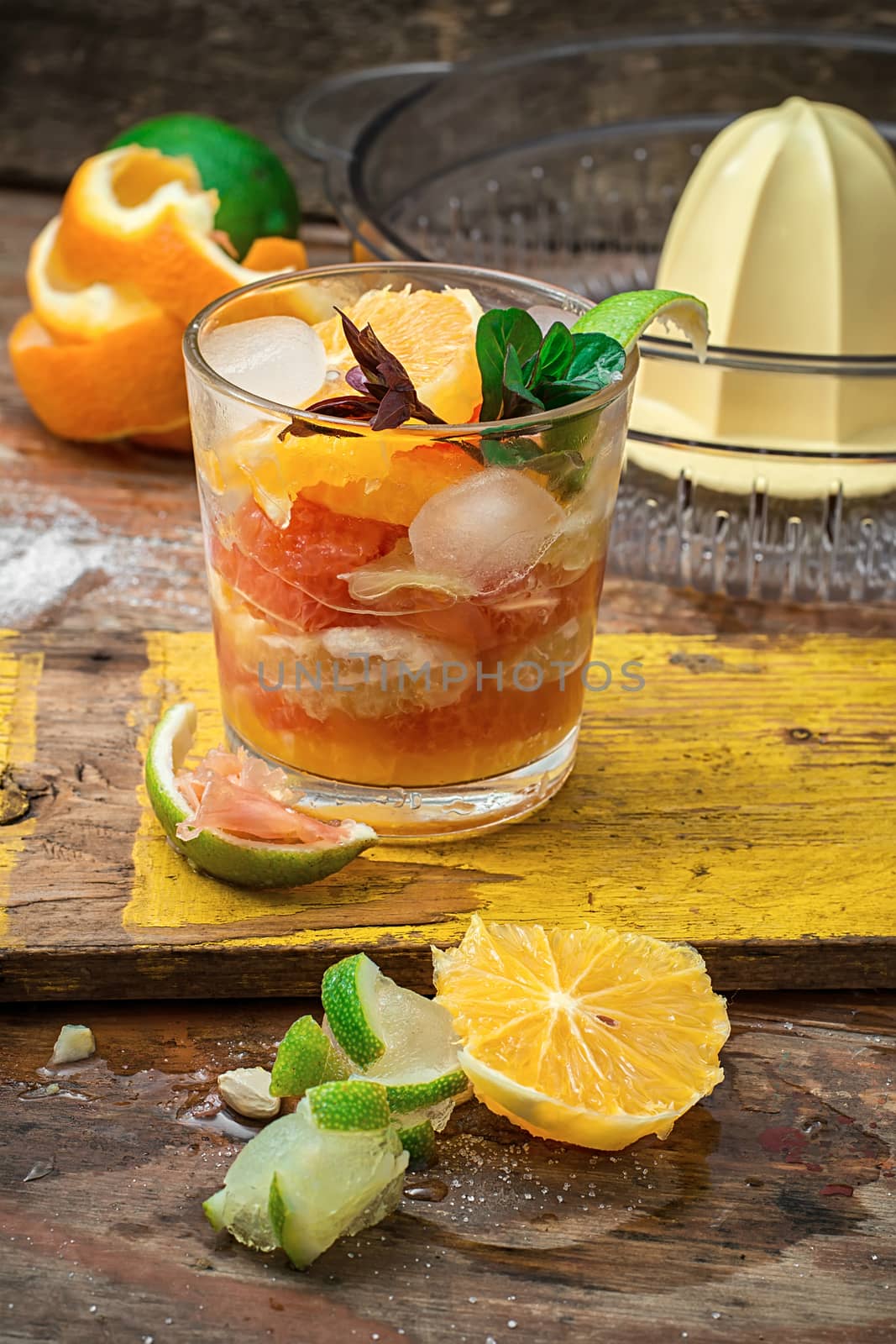 fresh juice of tropical citrus fruits on wooden background.Selective focus