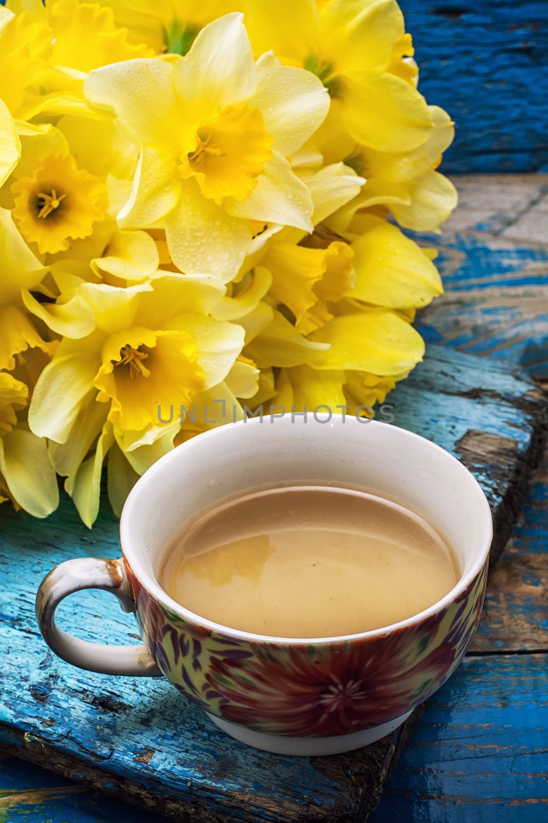 Cup of tea and a bunch of fresh daffodils