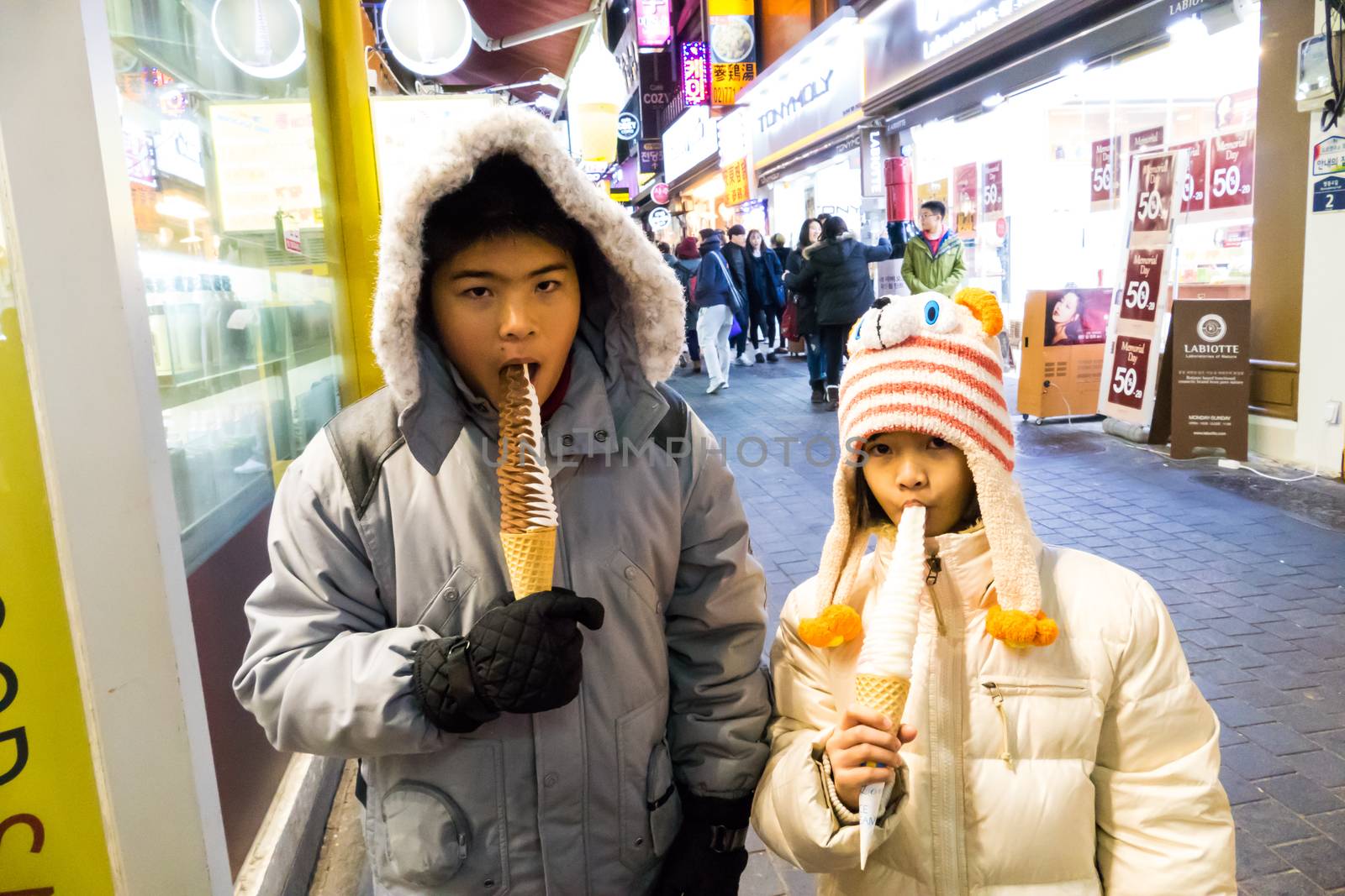 SEOUL - JANUARY 30: Korean people and tourists walking shopping at Myeongdong Market shopping street (It is popular and latest fashion center of Korea) on January 30, 2016 at Myeongdong Market in Seoul, South Korea.