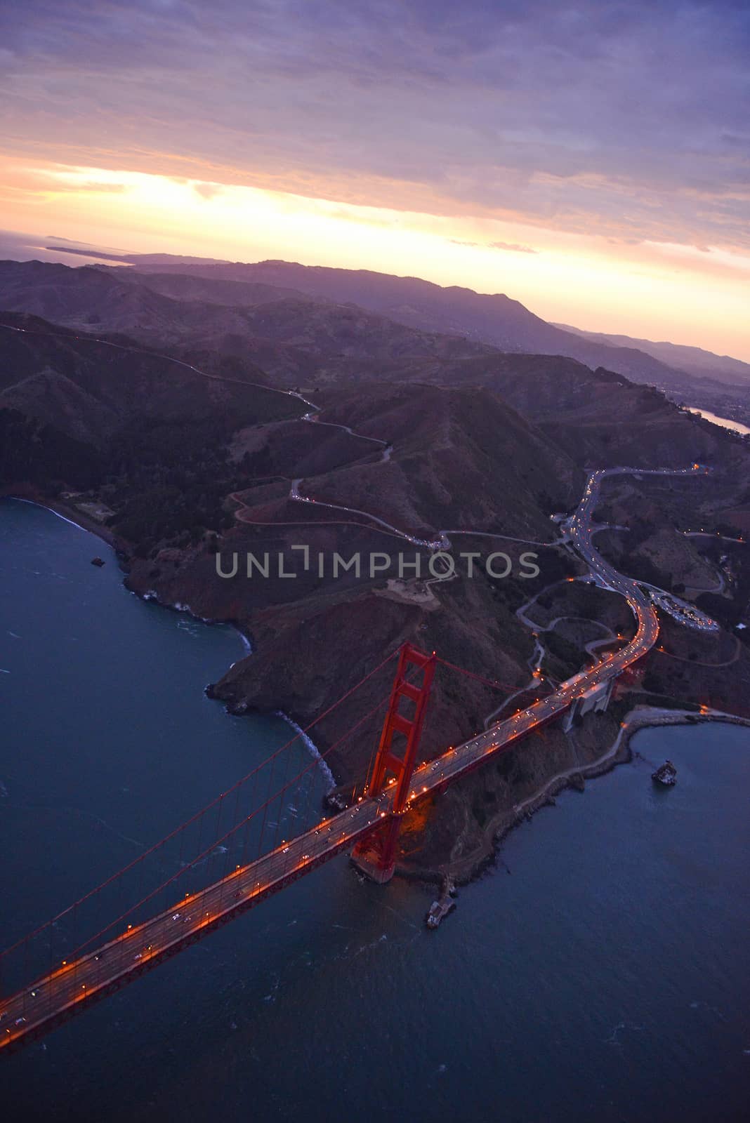 an aerial view of golden gate bridge in san francisco during sunset, taken from a helicopter