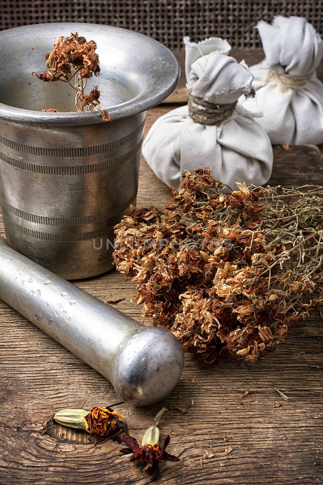 iron mortar and pestle with dried medicinal herb in the rural style.Selective focus