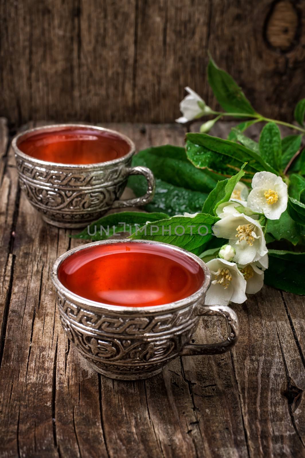 still life with old cups of brewed herbal tea and scattered welding